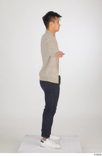 Yoshinaga Kuri blue jeans brown sweater casual dressed standing t…
